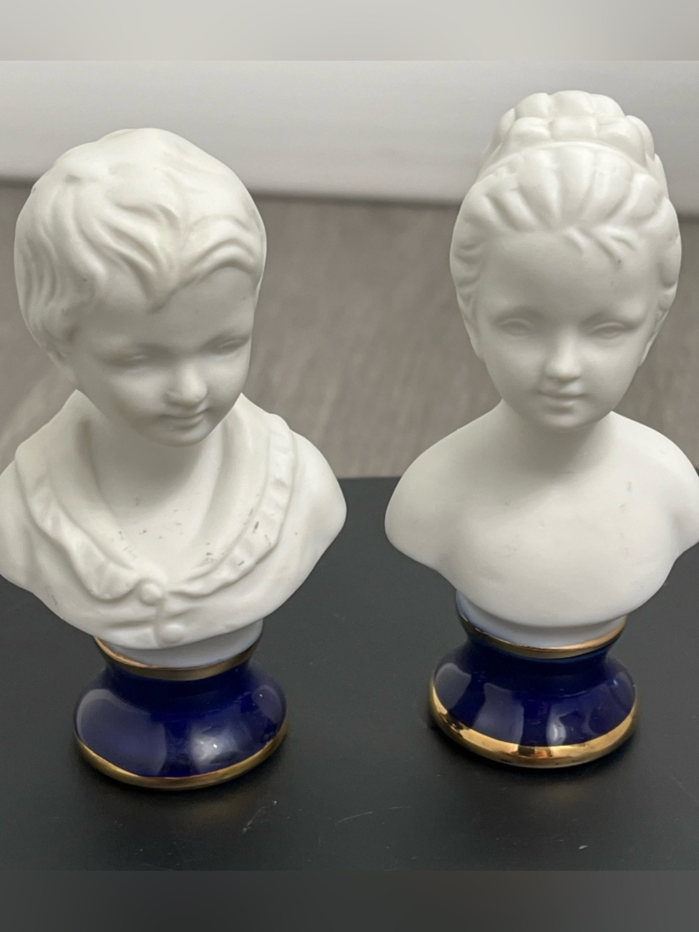 Vintage bisque porcelain busts on a cobalt base boy and girl